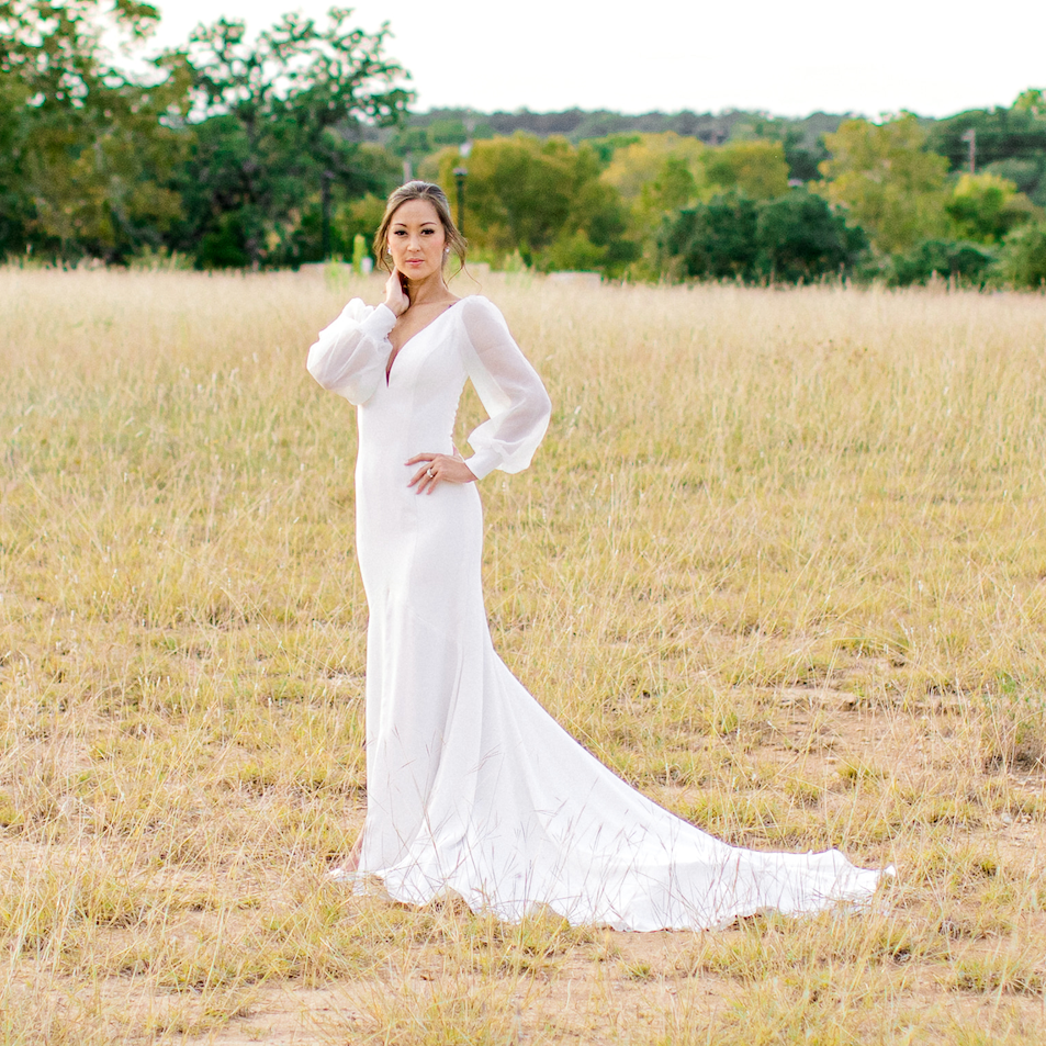 Model wearing a white gown. Mobile image